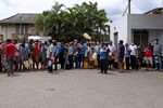 Customers queue with their containers to buy fuel at a gas station in Kandy, Sri Lanka, on Friday, June 17, 2022. 