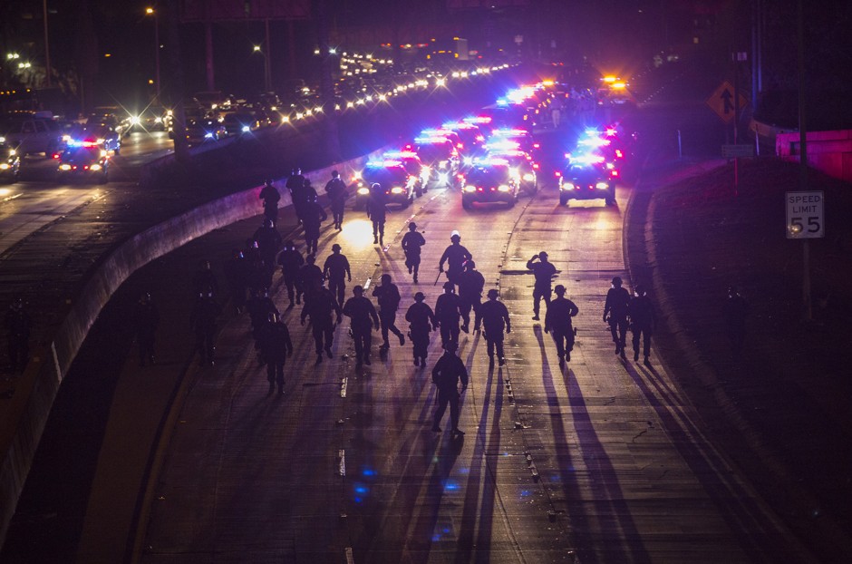 California Highway Patrol officers clear protesters from the 101 freeway in Los Angeles.