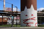 A mural of a cat sits on a chimney at the Severstal PJSC facility in Cherepovets.