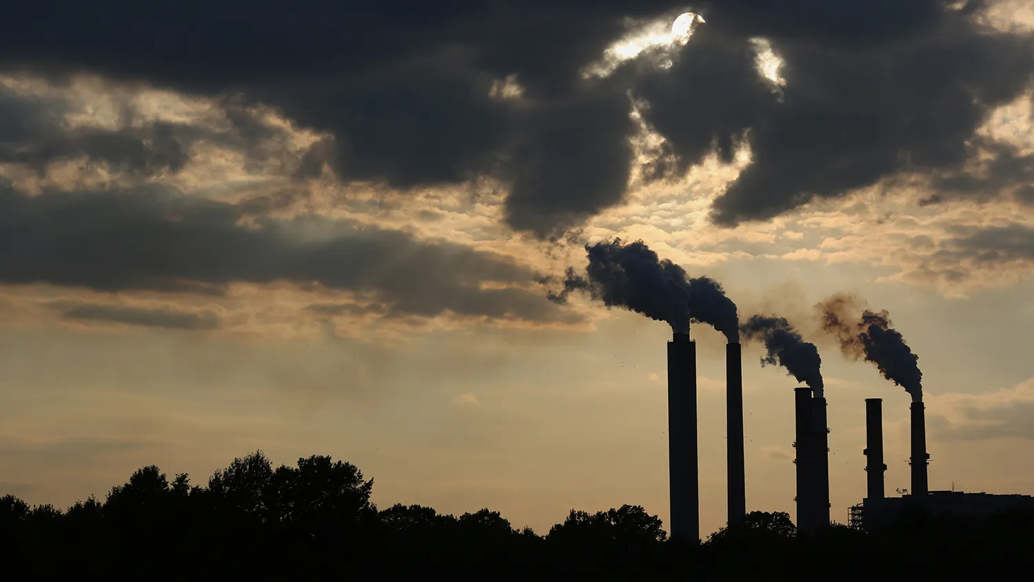 The silhouettes of emissions are seen rising from stacks of the Duke Energy Corp. Gibson Station power plant at dusk in Owensville, Indiana, U.S., on Thursday, July 23, 2015.
