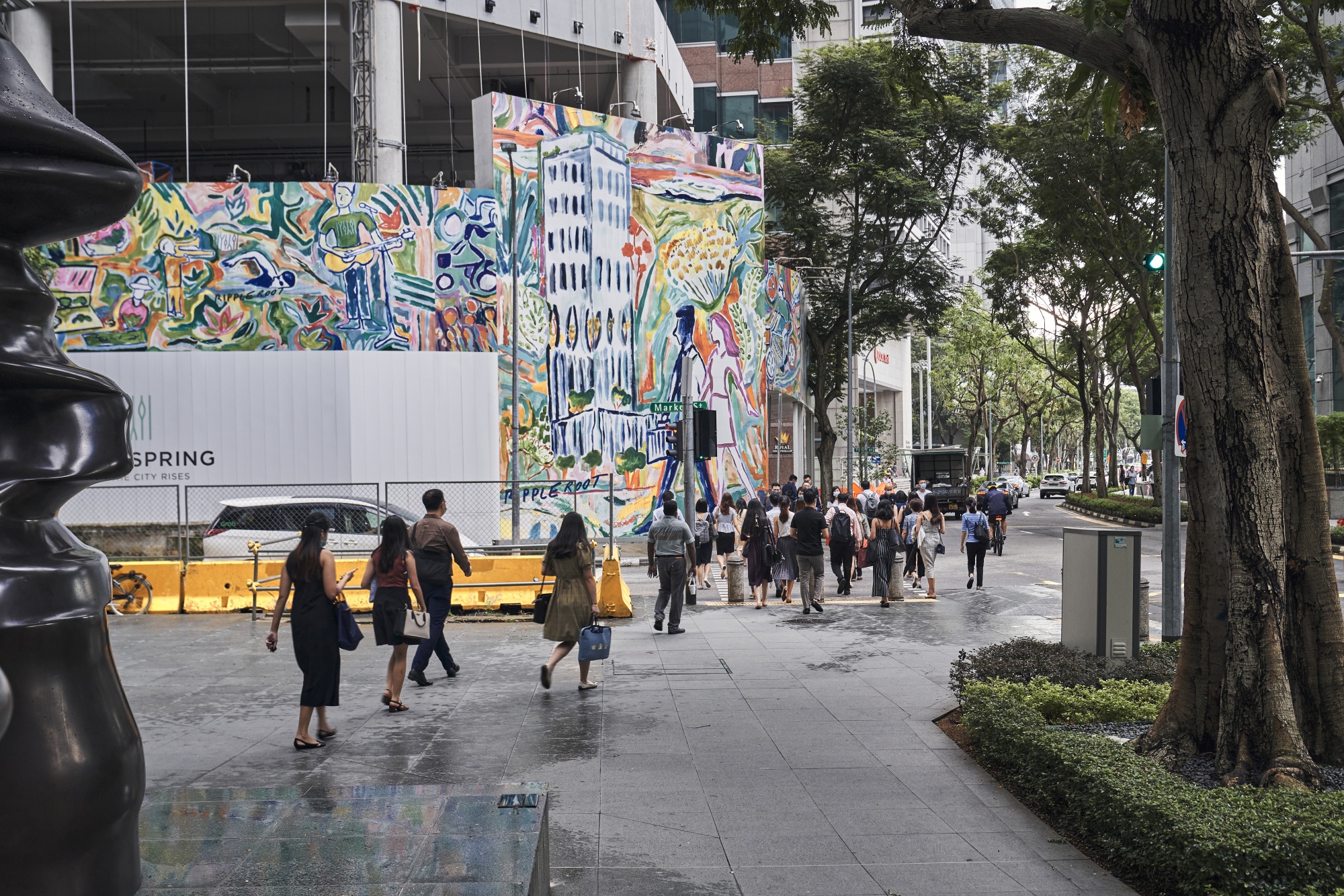 Pedestrians cross a street in Raffles Place in Singapore.