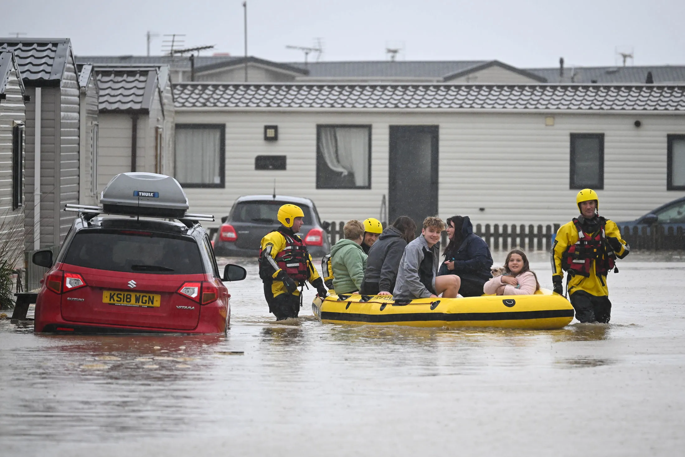 Rescue workers evacuate people from chalets in Burton Bradstock, Dorset, UK, on Nov. 2.