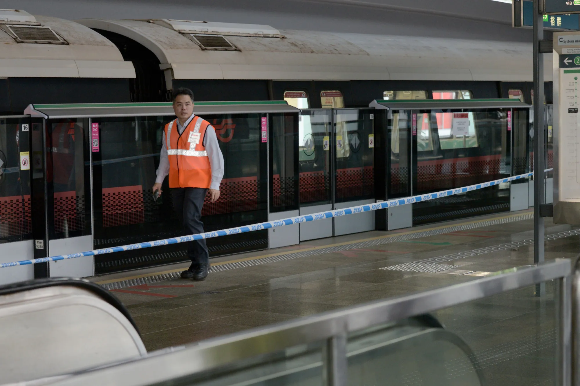 A SMRT employee walks past one of the two trains that collided at a train station in Singapore on Nov. 15