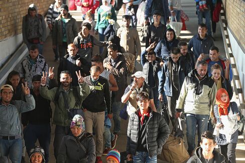 Migrants disembark from a government-chartered train that brought them to Berlin, Germany.