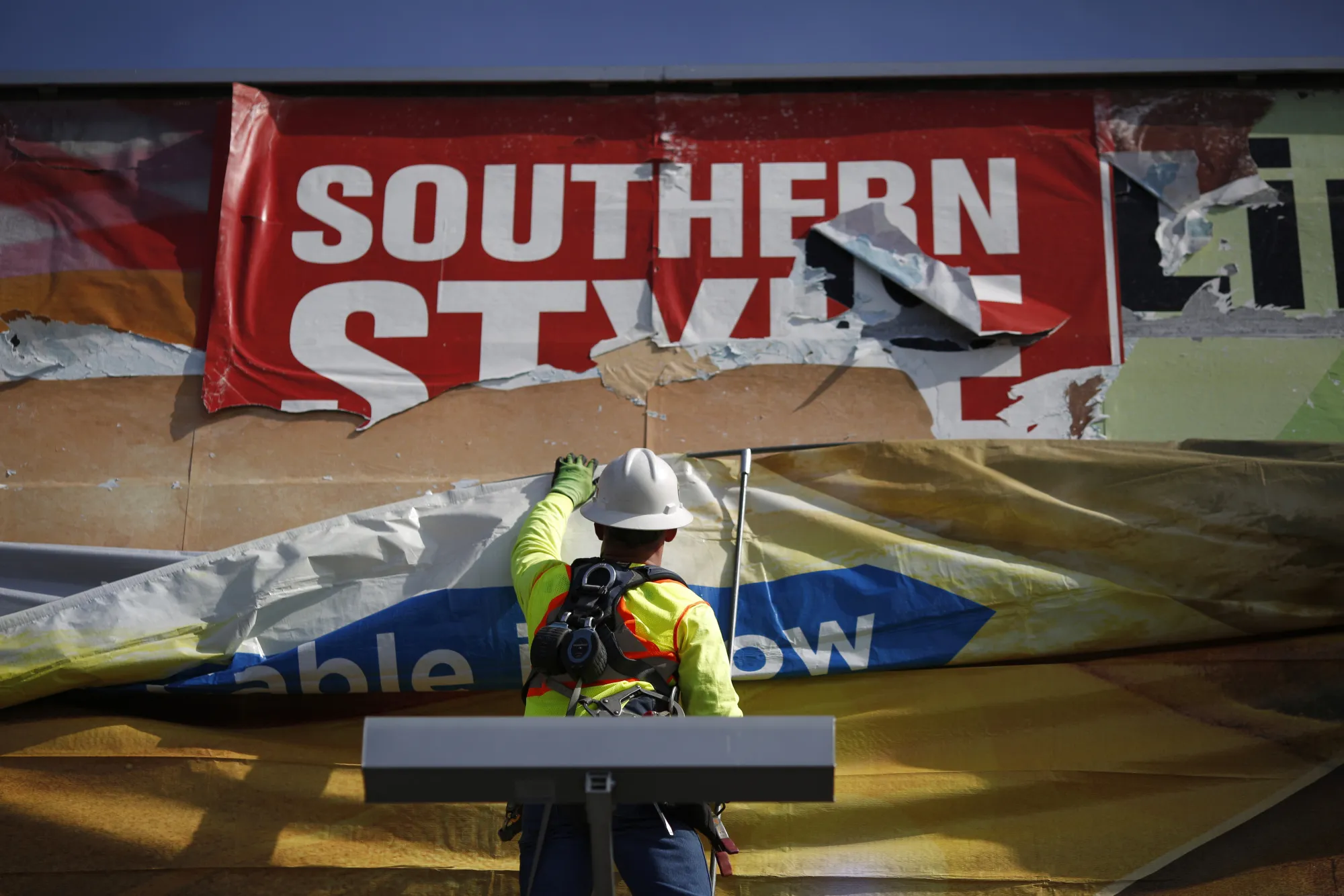 Workers Change Advertisements On Lamar Advertising Co. Billboards As Earnings Figures Are Released 