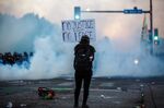 A demonstrator holds a sign during a demonstration to call for justice for George Floyd, in Minneapolis, May 30.