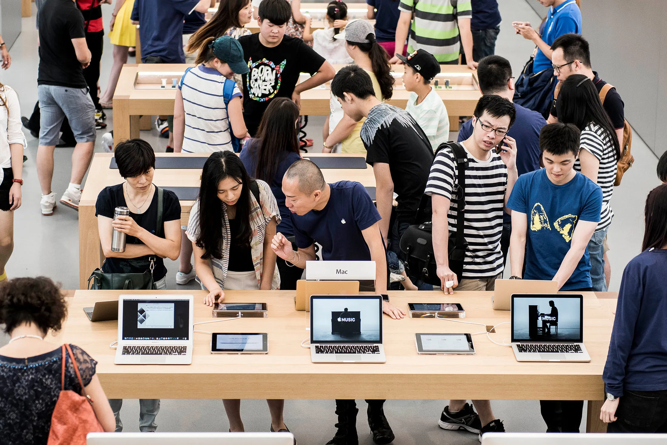 Customers look at laptops at Apple’s new Canton Road store in the Tsim Sha Tsui district of Hong Kong on July 30.
