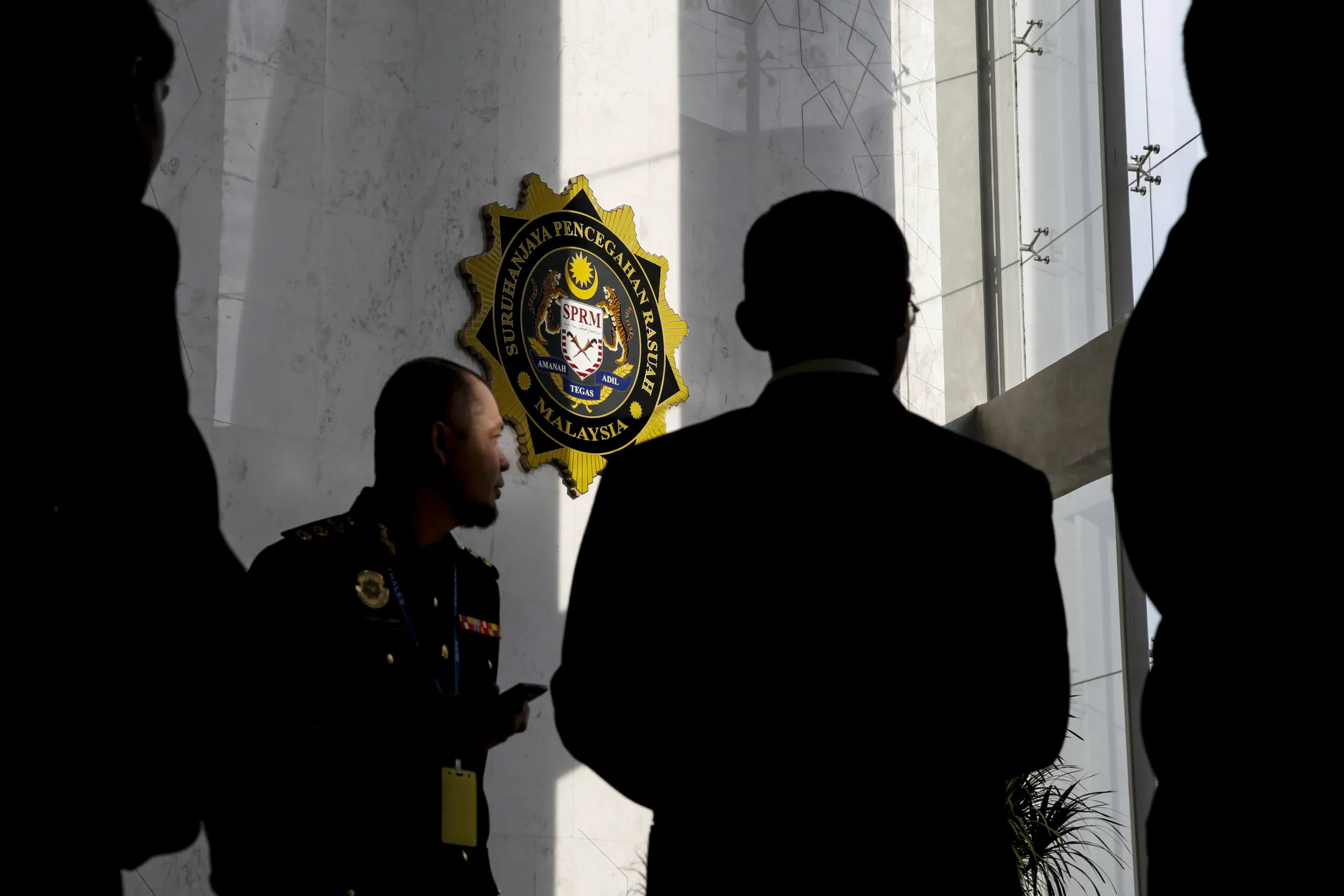 Malaysian Anti-Corruption Commission officers stand at the agency's headquarters on May 24.