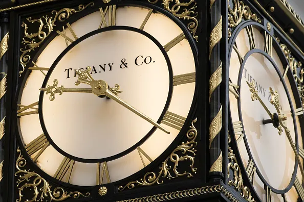 A branded clock hangs in front of a Tiffany &amp; Co. luxury jewelry store in London.