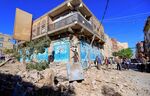 Yemenis inspect damage following a reported overnight air strike by the Saudi-led coalition targeting in the Huthi rebel-held capital Sanaa, on Dec. 24