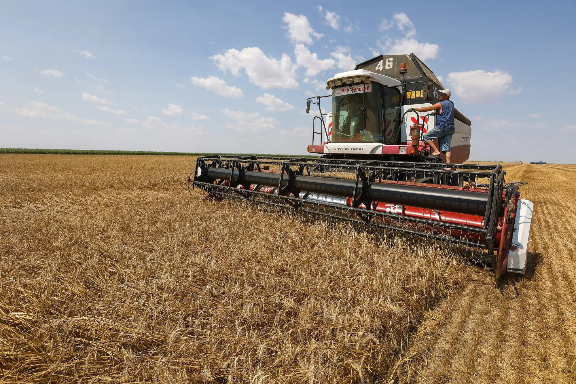 A combine harvester drives through a wheat field&nbsp;near Stavropol, Russia.