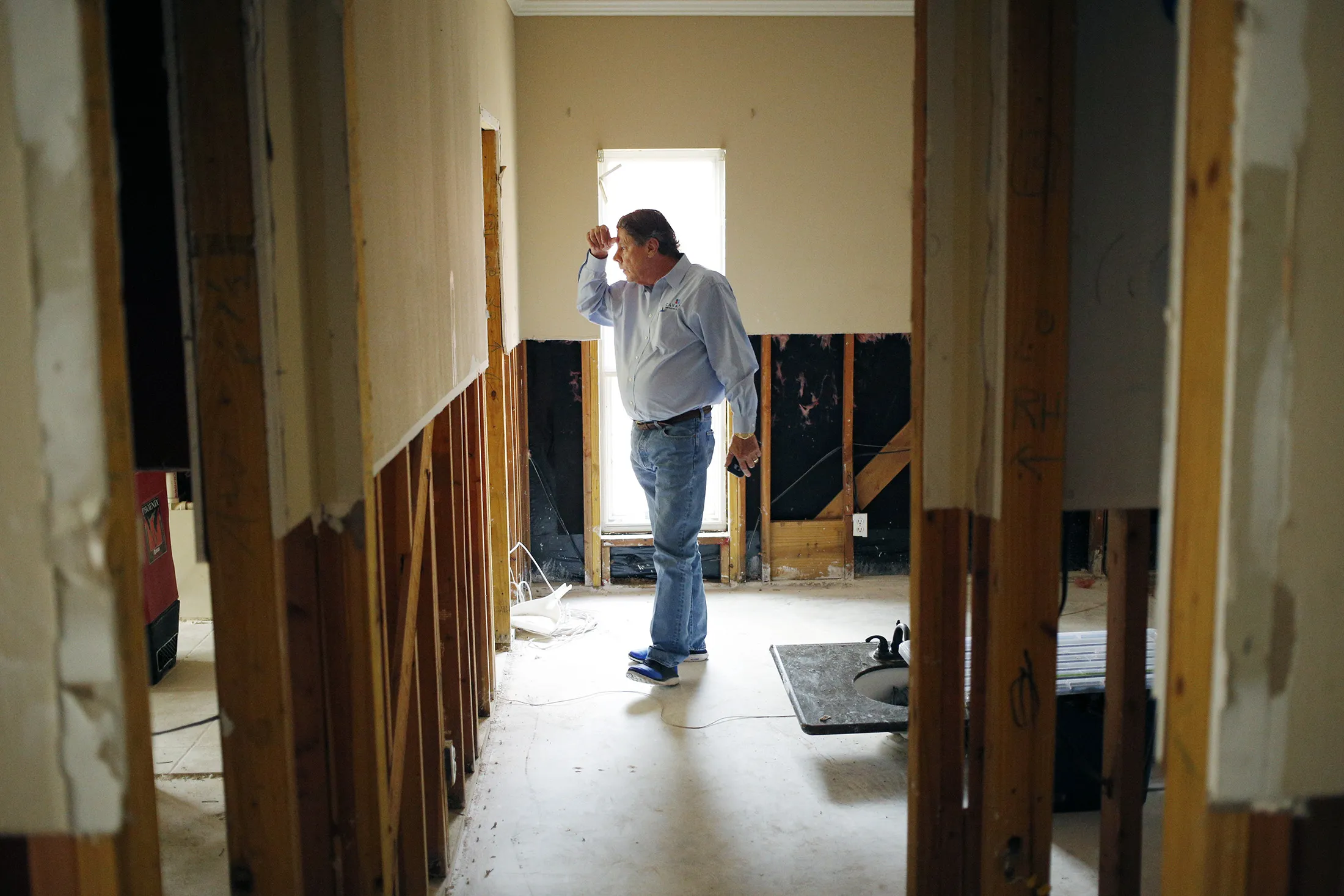 Frank Jones, owner of Cavalry Construction, stands inside a house that was flooded by Hurricane Harvey in Spring, Texas, on Sept. 6, 2017.