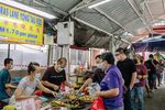 Customers in line for food at a market in Kuala Lumpur.
