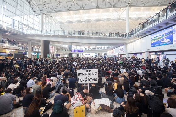 Hong Kong Protesters Clash With Police, Occupy Airport