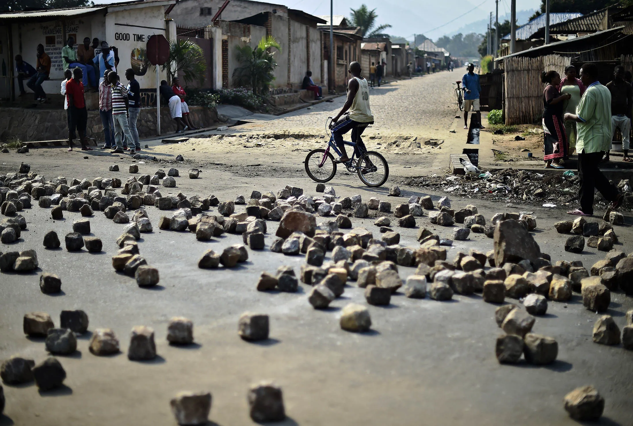 A man cycles past a barricade set up by protestors in the Nyakabiga neighborhood in Bujumbura.
