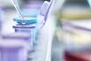 Pipetting droplets of liquid into eppendorf tubes, side view