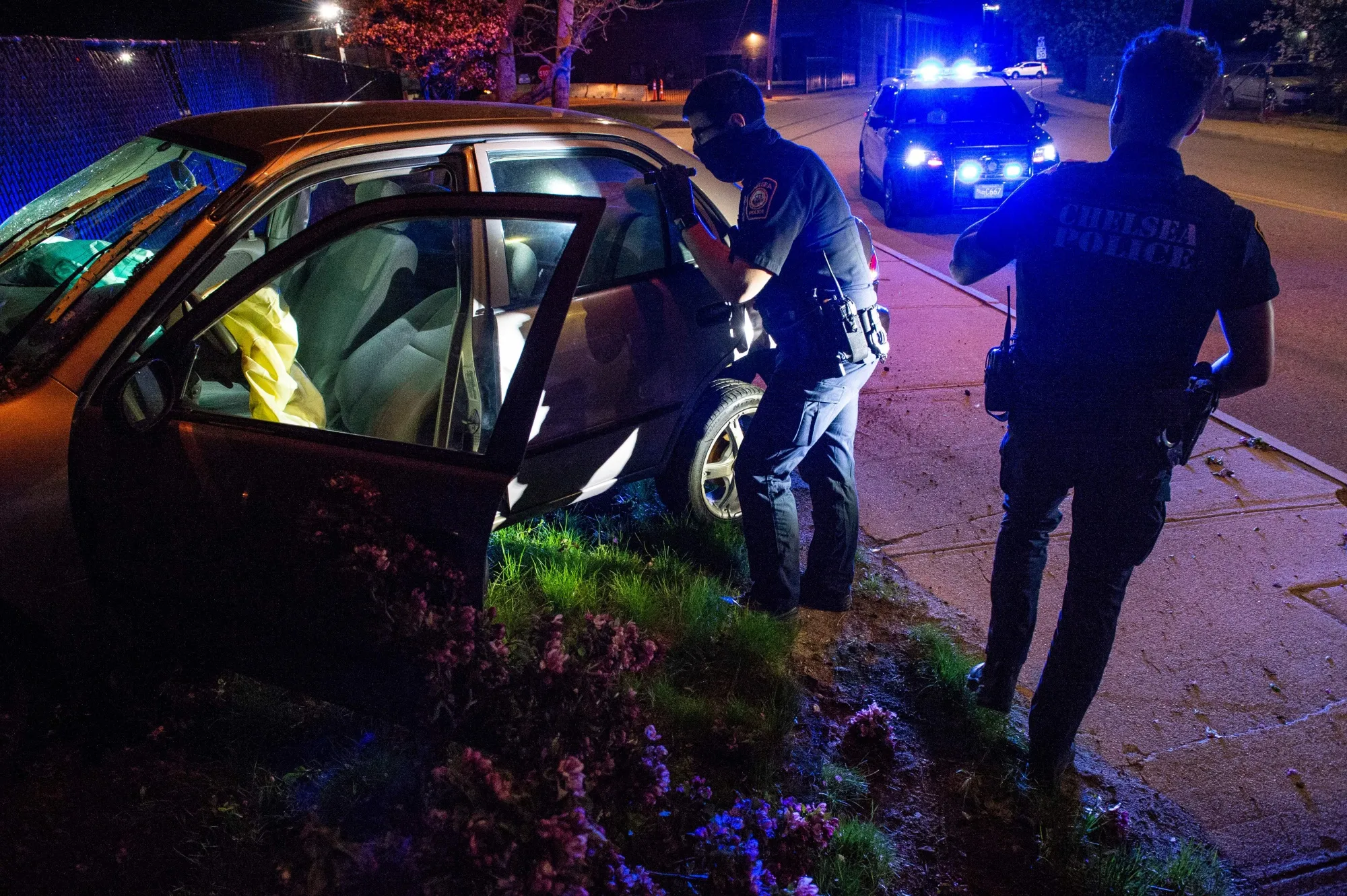 Police in Chelsea, Massachusetts, inspect a vehicle after a crash in May&nbsp;2021.