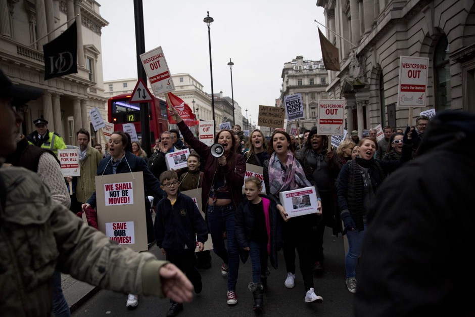 Residents from the New Era estate in East London, originally built as affordable housing for local workers, march through central London Monday, Dec. 1, 2014. 