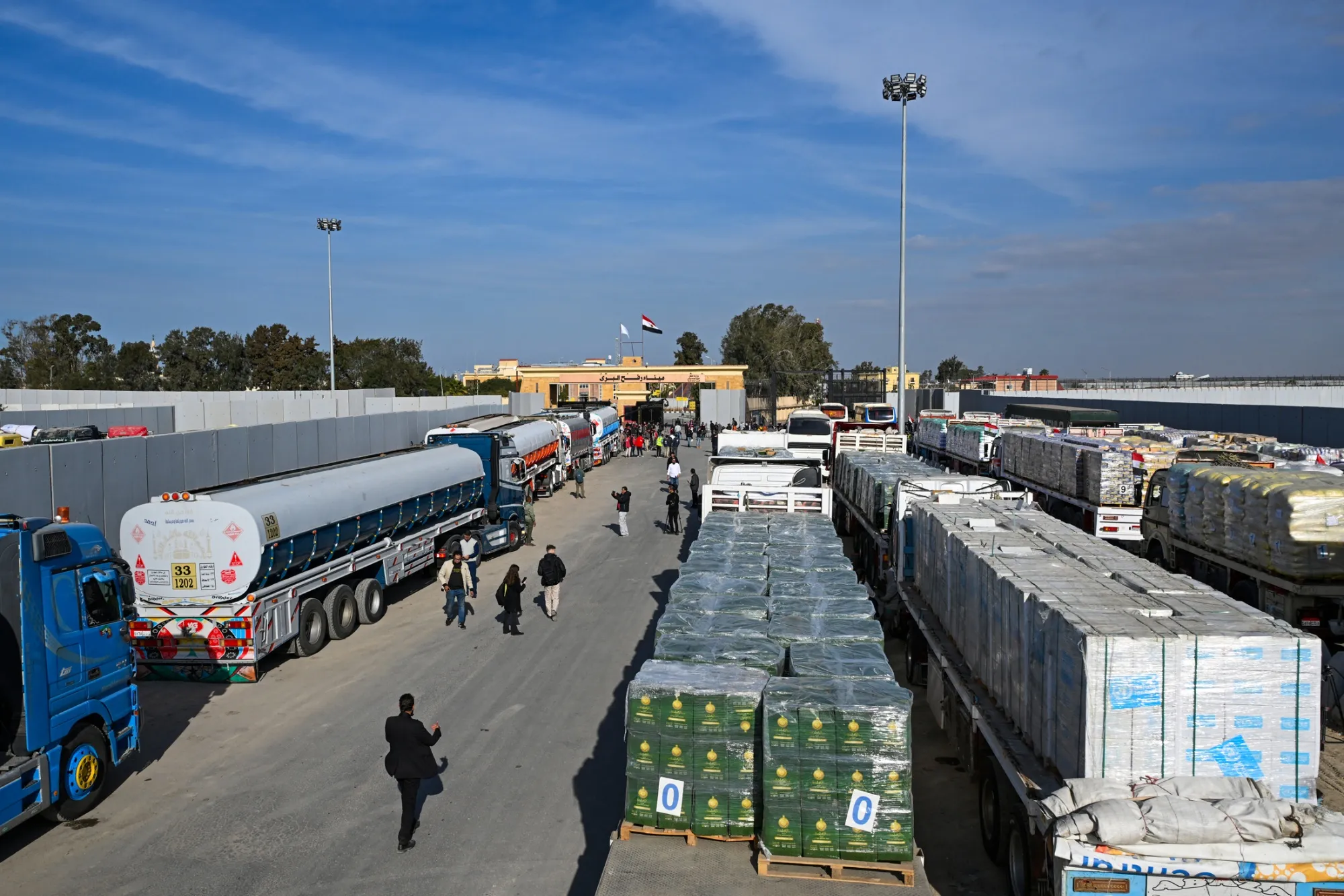 Trucks loaded with aid wait to cross into Gaza from the Egyptian side of the Rafah border crossing.