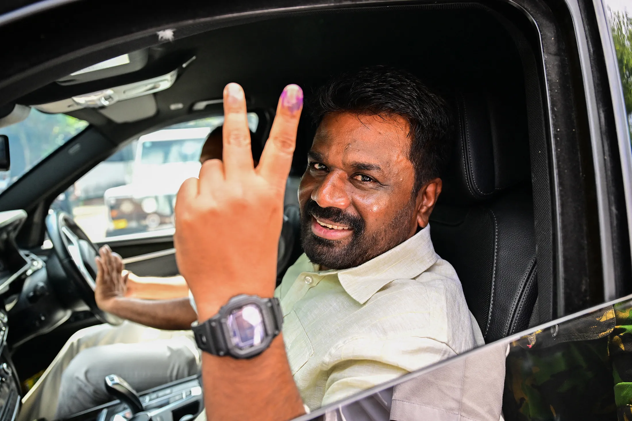 Anura Kumara Dissanayake shows his inked finger as he leaves a polling station&nbsp;in Colombo on Nov. 14.
