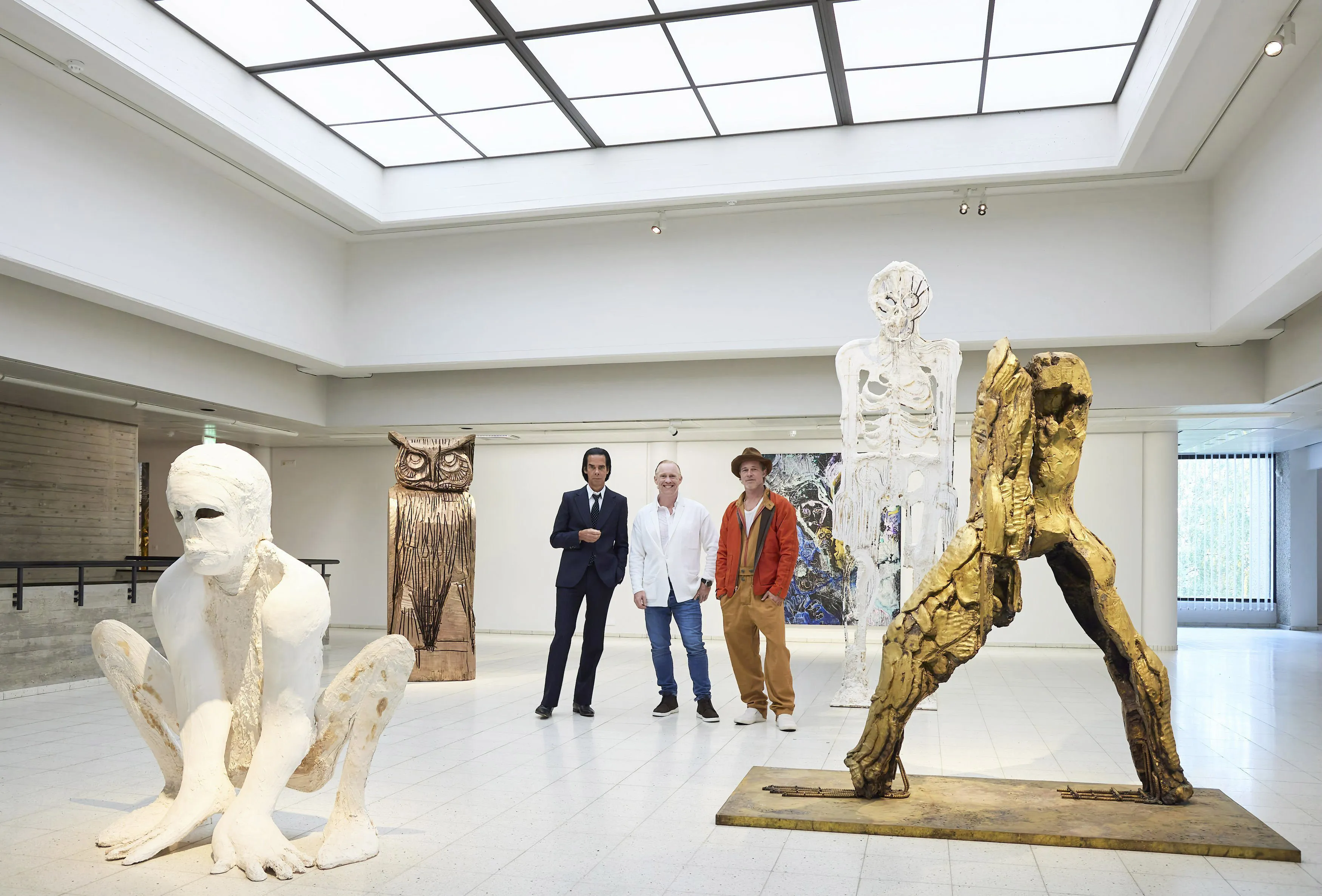 In this photo provided by Sara Hilden Art Museum, British artist Thomas Houseago, centre, poses with US actor Brad Pitt, centre right and Australian musician Nick Cave, prior to the opening of their joint exhibition, in Tampere, Finland, Saturday, Sept. 17, 2022. (Jussi Koivunen/Sara Hilden Art Museum, Lehtikuva via AP)