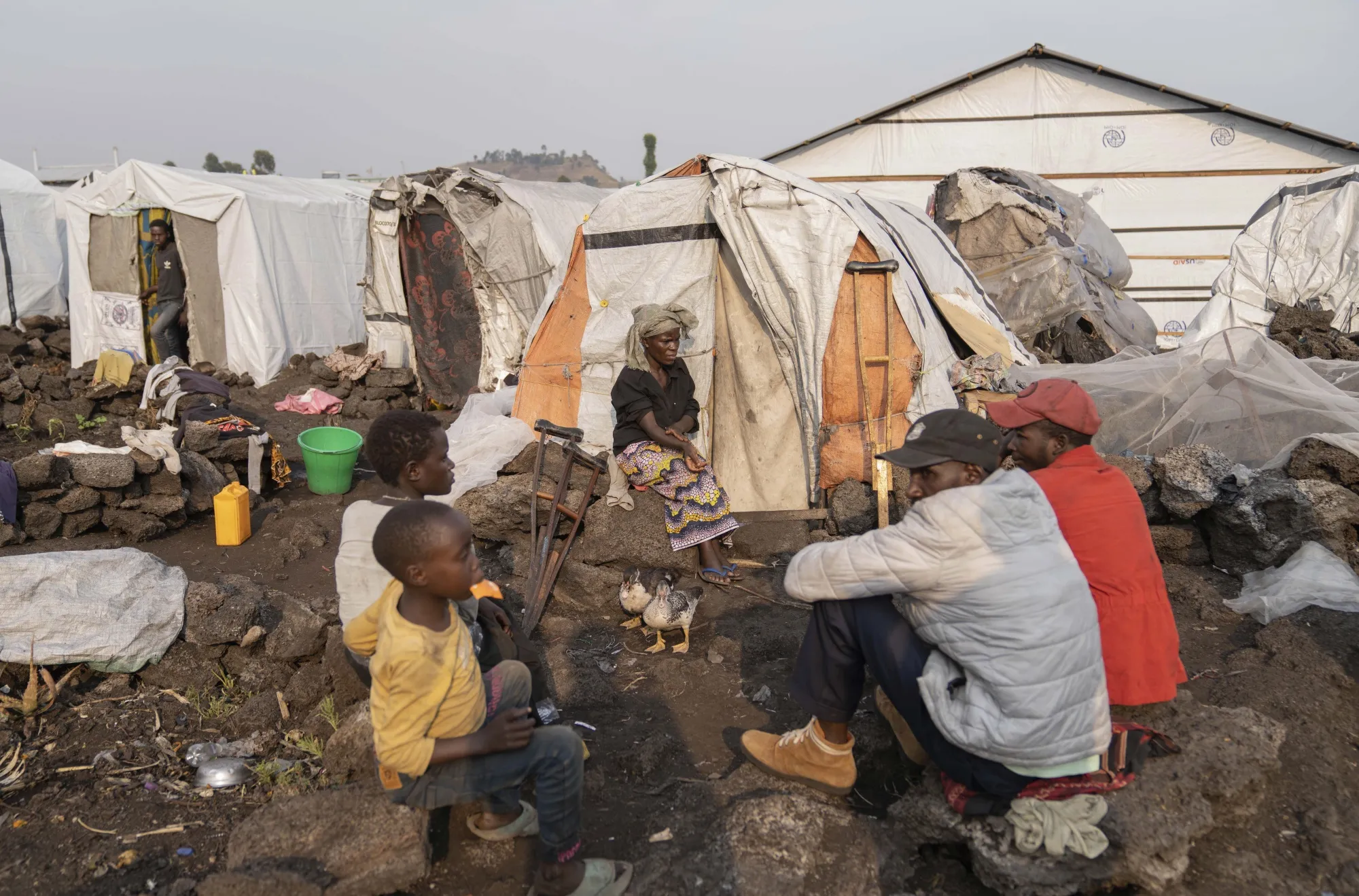 A woman, center back, suspects she may be infected with mpox, in the Bulengo refugee camp in Goma, Congo.
