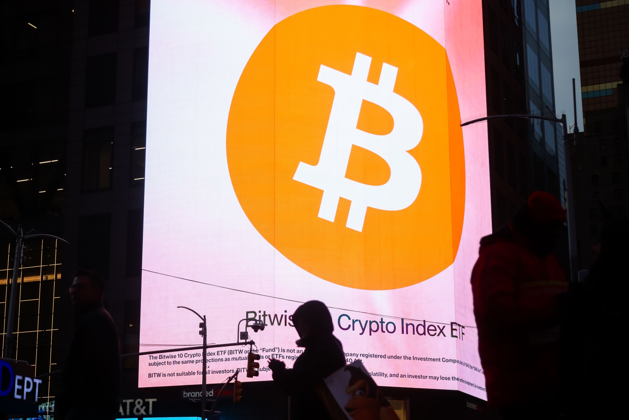 Bitcoin signage in Times Square in New York, US, on Tuesday, Dec. 9, 2025. The market is still reeling from a flash crash on Oct. 10 that saw more than $19 billion of crypto bets liquidated, and spot trading volumes have fallen 66% since their January highs. Photographer: Michael Nagle/Bloomberg