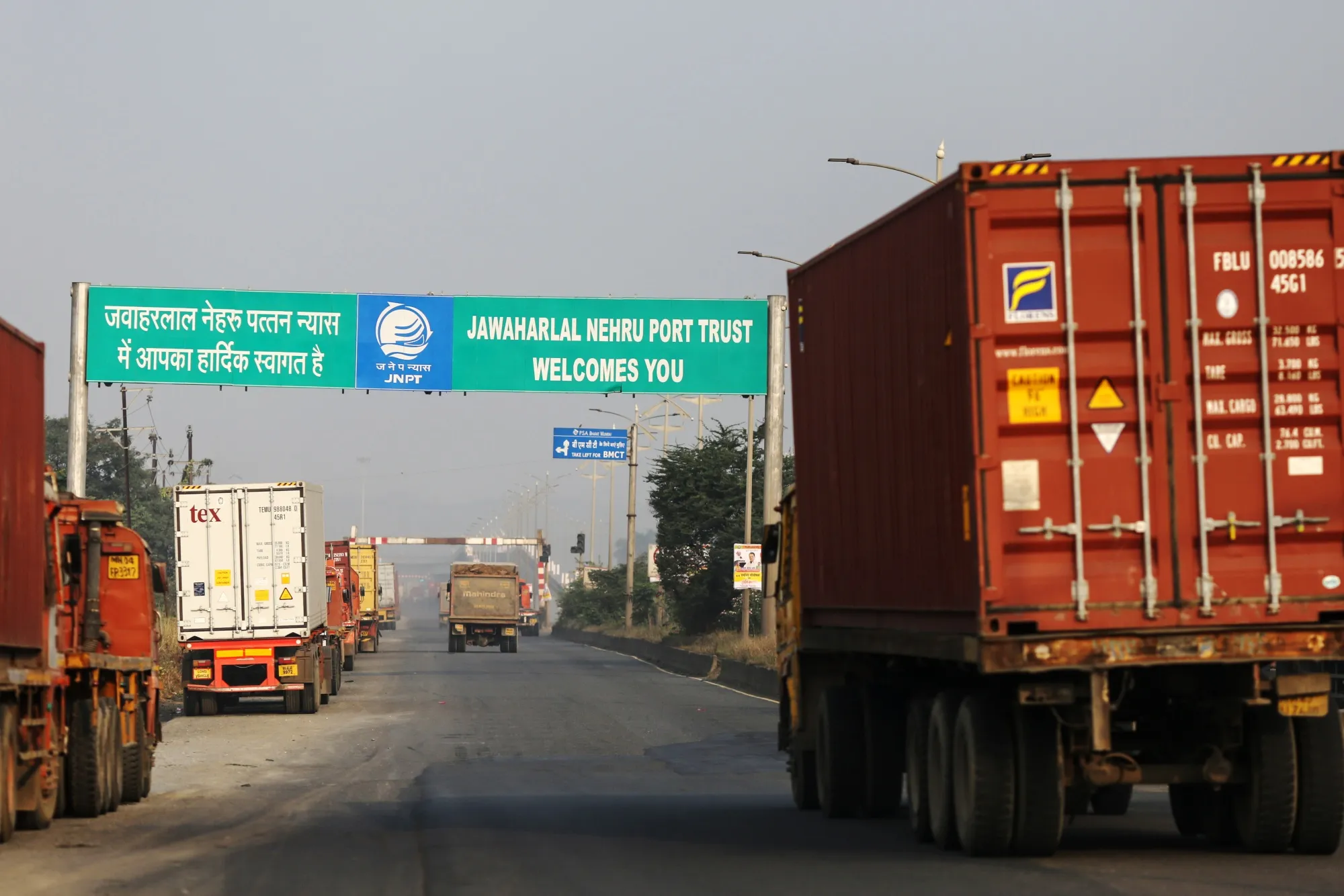 Trucks transporting shipping containers enter the Jawaharlal Nehru Port in Navi Mumbai.