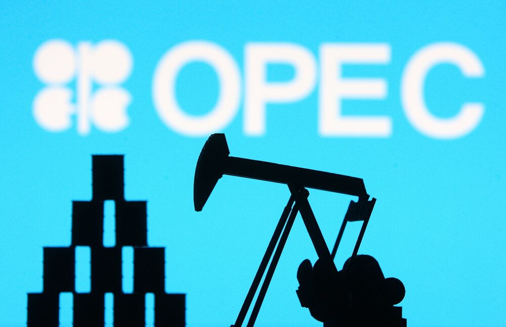 OPEC organization logo and miniature models of an oil derrick pump and oil barrels are pictured in this illustration photo taken in Kyiv.