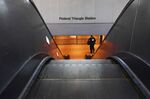 A transit officer is seen at a closed Federal Triangle Station in Washington, DC. The region’s public transit agency released a plan to close 19 stations, among other cuts, unless federal aid provides some financial&nbsp;relief.&nbsp;