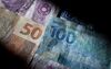 Brazilian real bank notes are arranged for a photograph in Washington, D.C., U.S., on Monday, Sept. 26. Speculation the sinking real will deepen Gol Linhas Aereas Inteligentes SA's worst quarterly loss since 2008 is driving the Brazilian airline's borrowing costs to a record high relative to rival Tam SA.