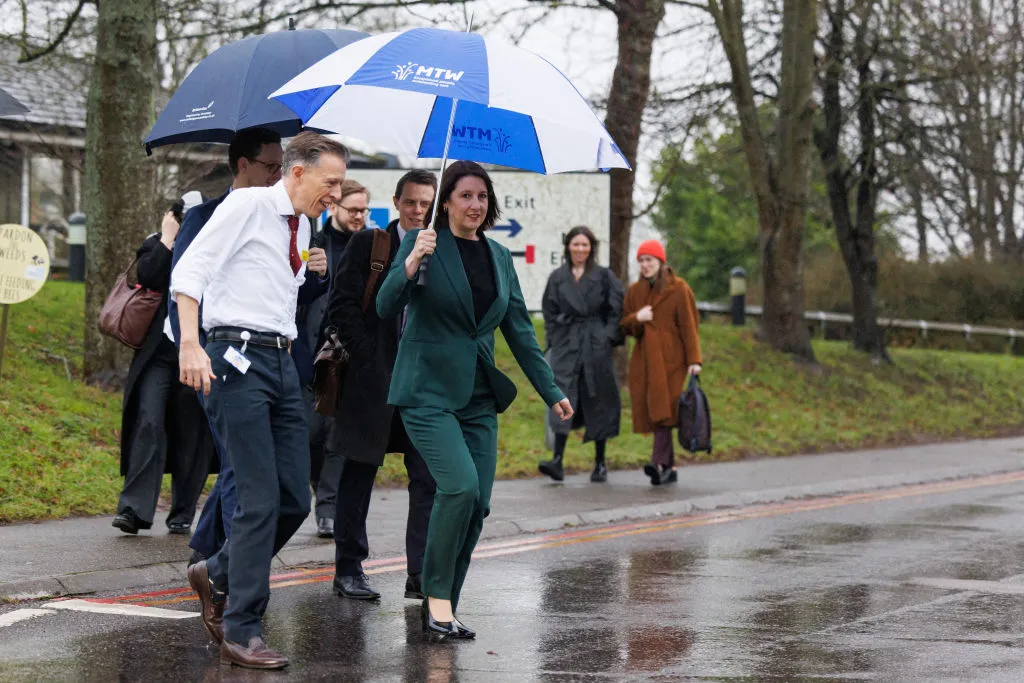 Britain's Chancellor of the Exchequer Rachel Reeves shelters from the rain during a tour of Maidstone Hospital in south east England last month.
