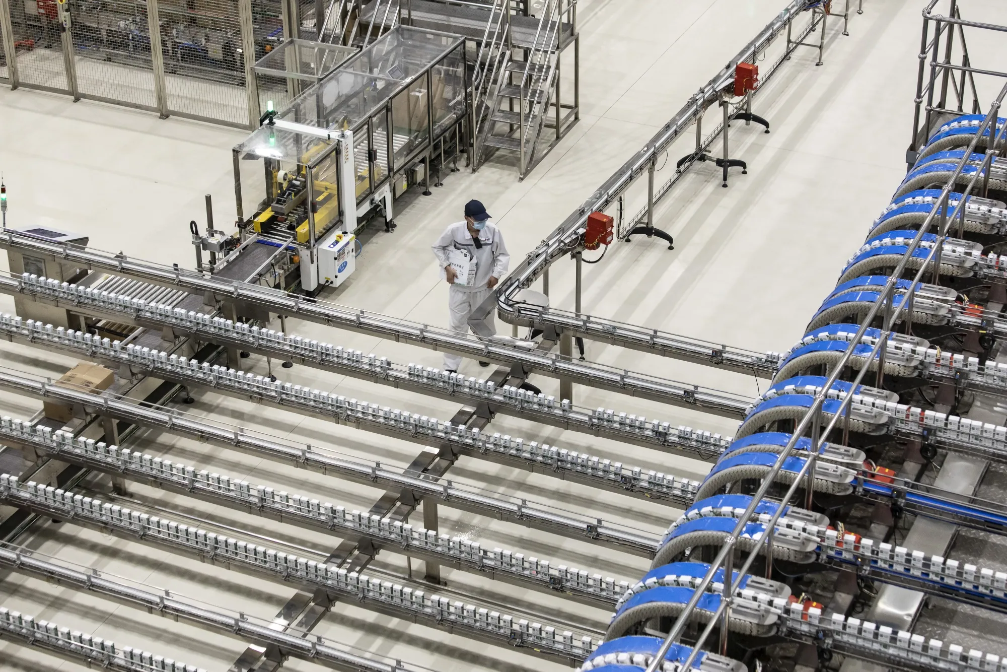 Dairy products move along production lines at Inner Mongolia Yili Industrial Group Co.'s Global Intelligent Manufacturing Industrial Park in Holhot, Inner Mongolia, China.