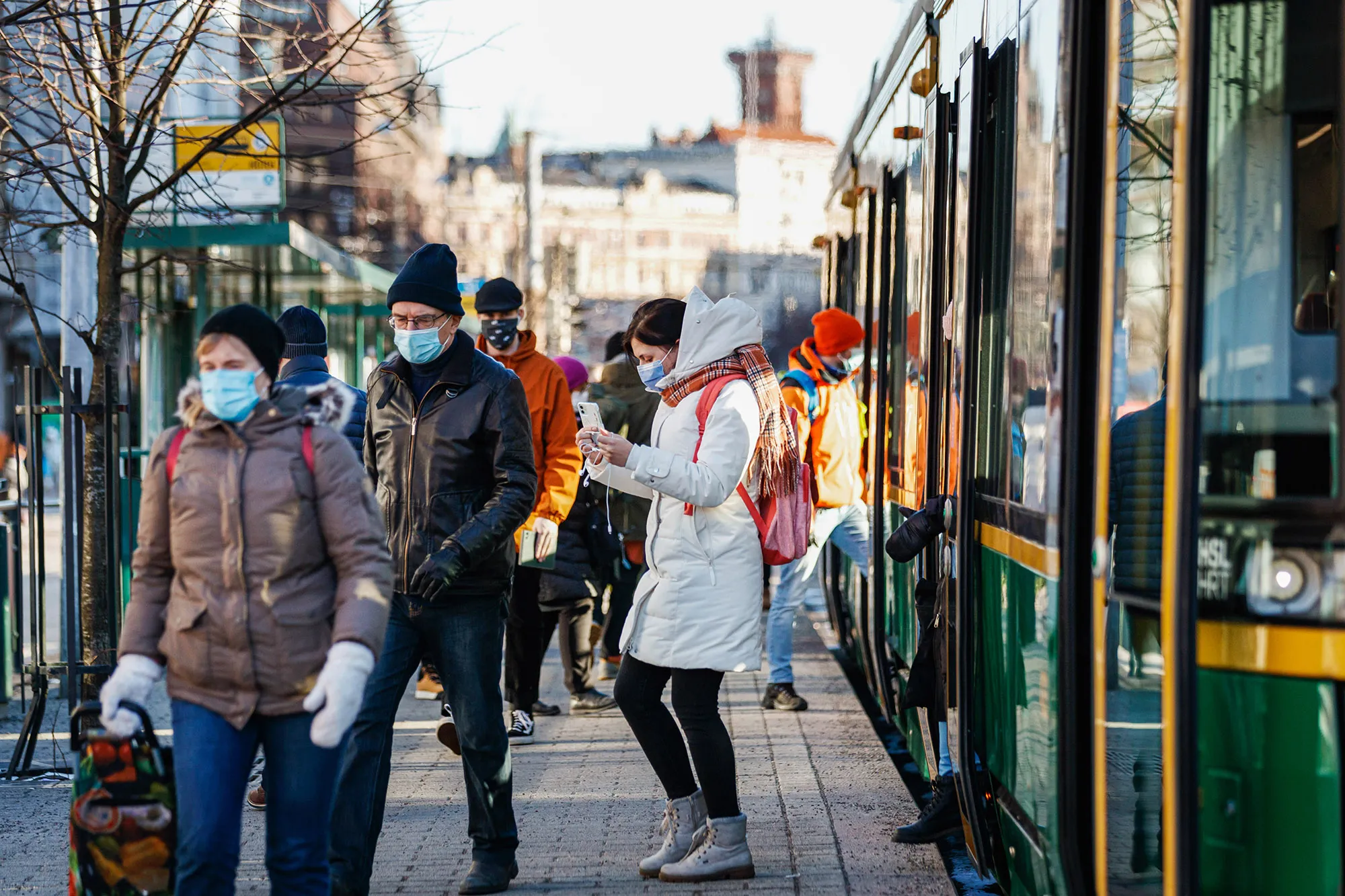 Commuters at a tram stop in Helsinki, Finland.