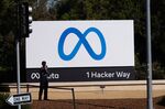 A visitor takes photographs in front of signage at Meta Platforms headquarters in Menlo Park, California, U.S., on Friday, Oct. 29, 2021.