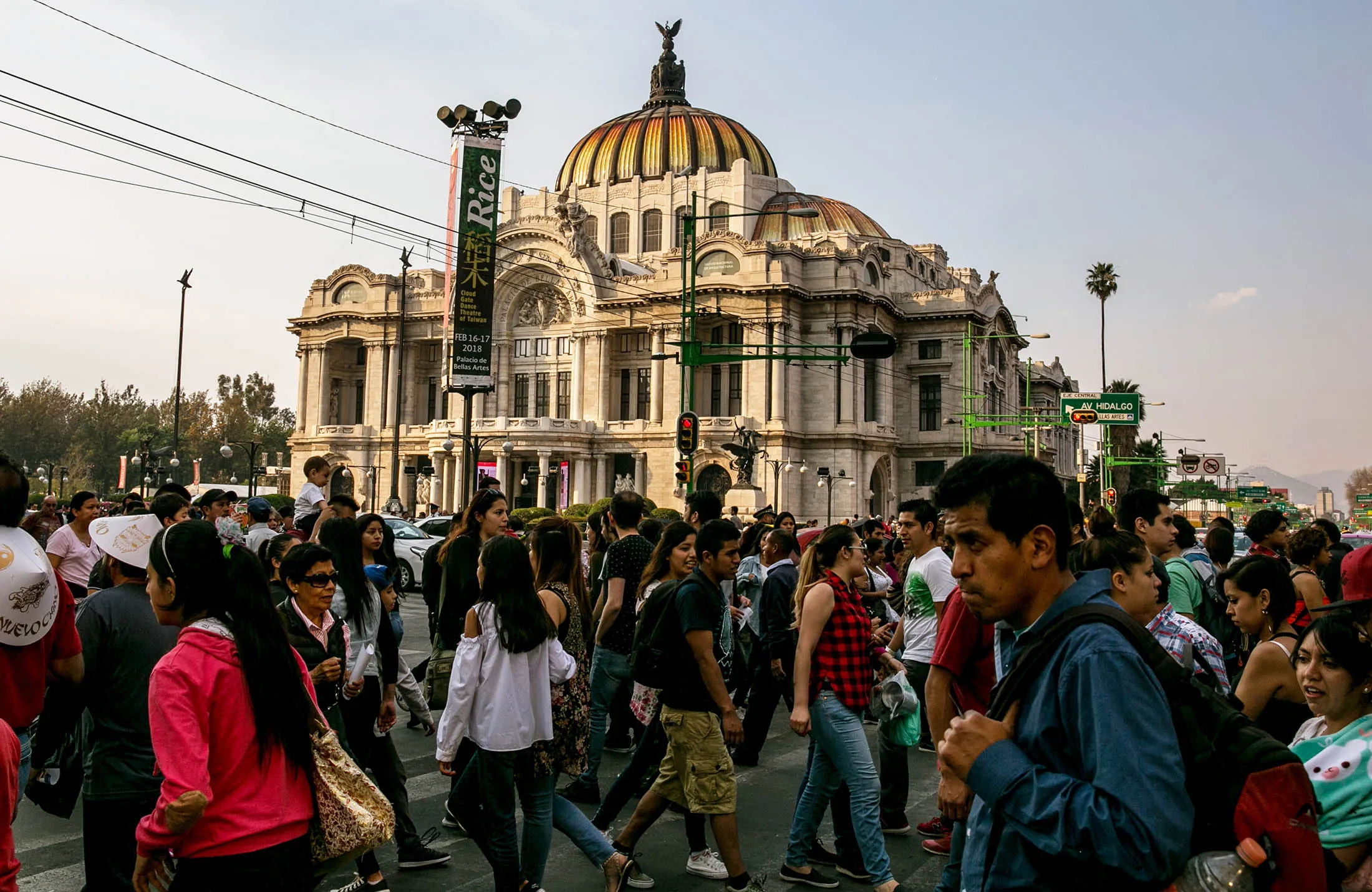 Pedestrians pass in front of the Palacio de Bellas Artes in Mexico City.