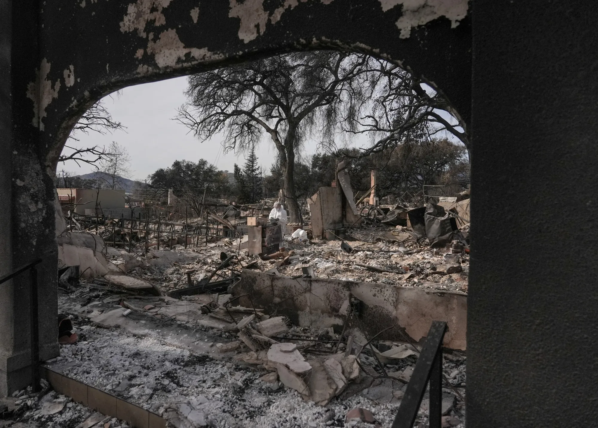 A worker sifts through the remains of a home destroyed by the Eaton fire in Altadena, California, on Jan. 22.