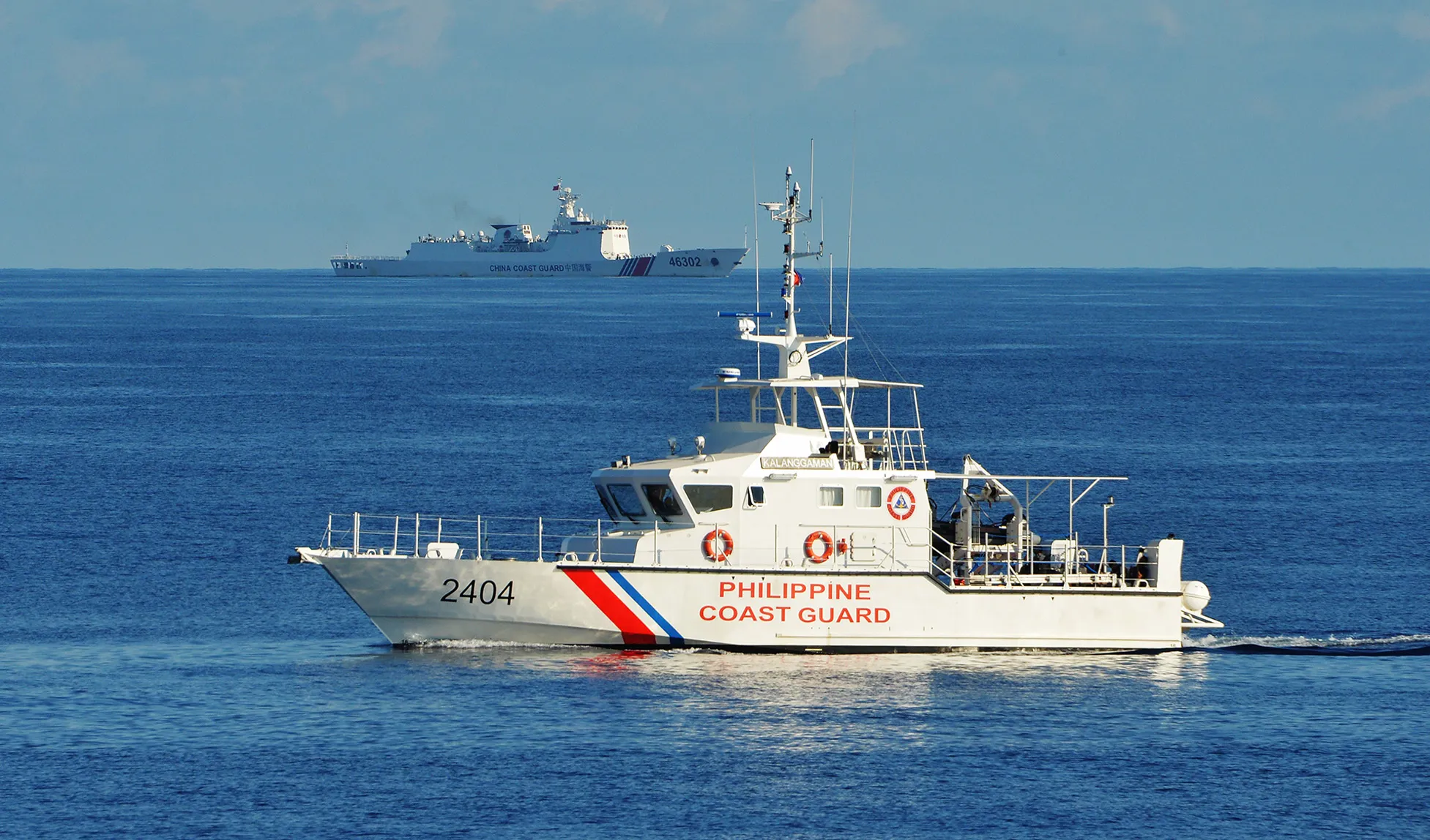 A Philippine coast guard ship&nbsp;sails past a Chinese coastguard ship during an joint&nbsp;exercise between Philippine and U.S. coastguards in 2019.&nbsp;