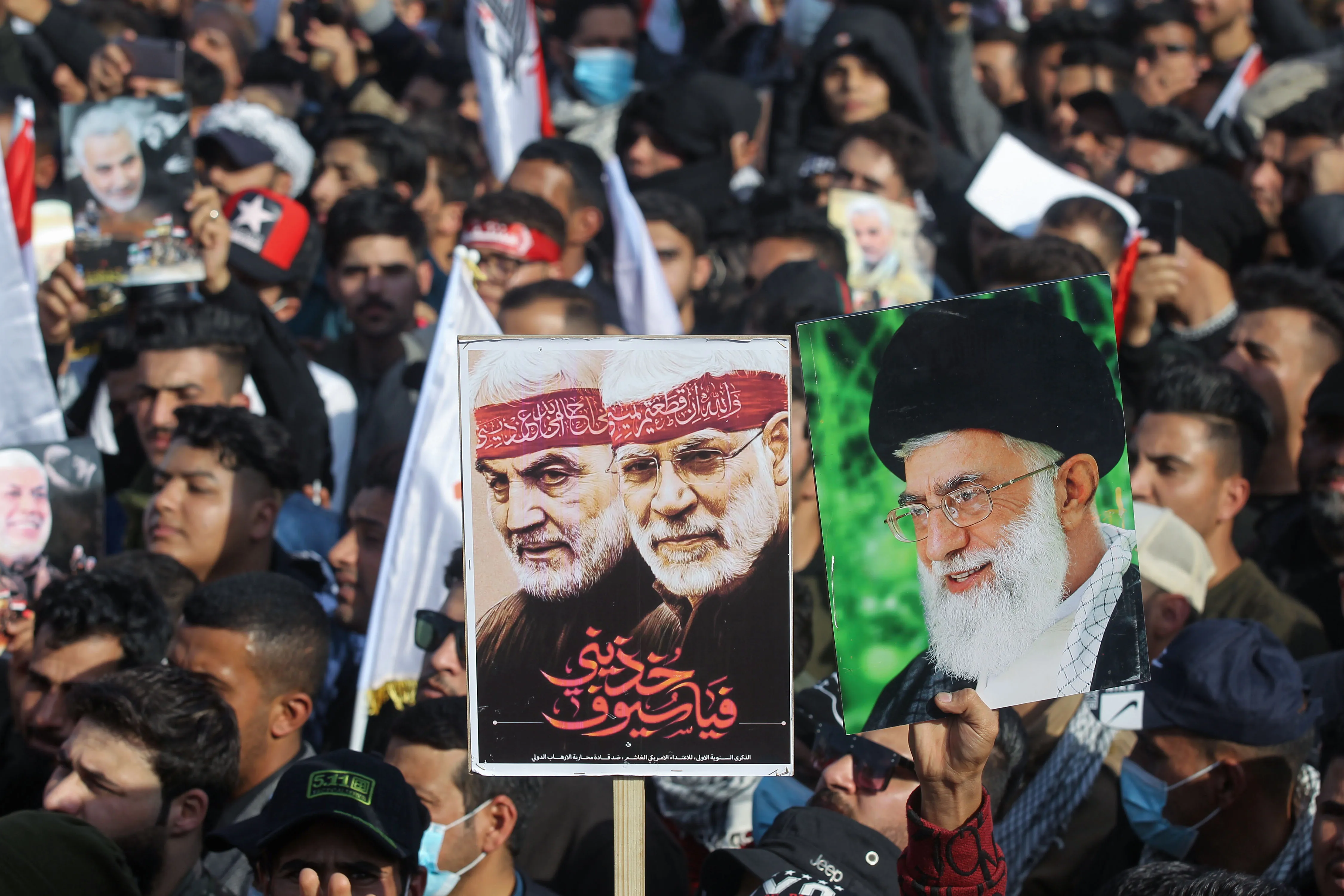 Iraqi demonstrators commemorate&nbsp;Iraqi commander Abu Mahdi al-Muhandis (C) and Iranian Revolutionary Guards commander Qasem Soleimani (L) and Iran's Supreme Leader Ayatollah Ali Khamenei (R).