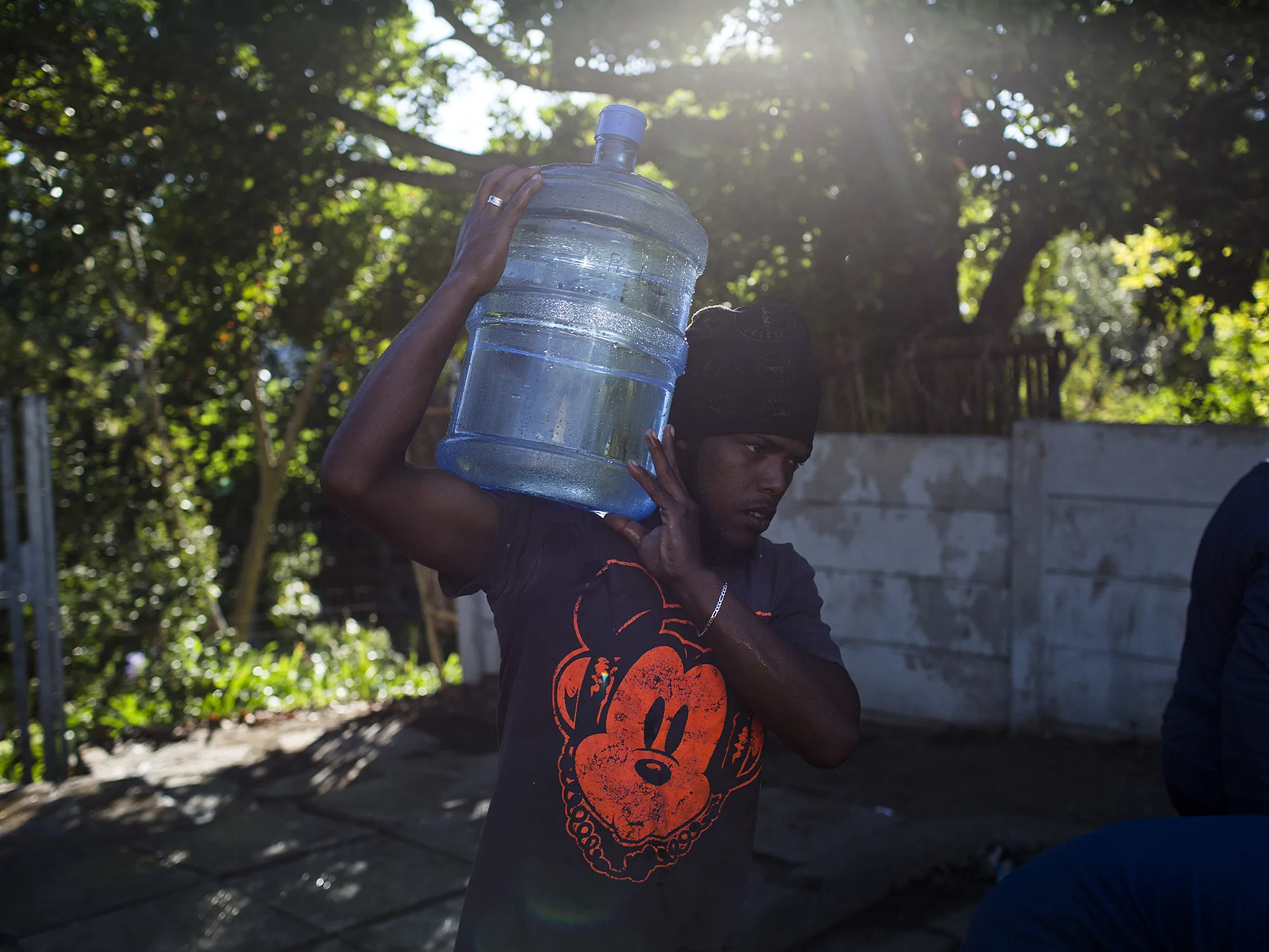 A man carries water at a&nbsp;spring in Cape Town.