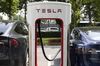 The Tesla Inc. logo is displayed on an electric vehicle charging station outside one of the company's showrooms in Beijing, China, on Friday, May 10, 2019. Beijing has vowed to retaliate after U.S. President Donald Trump followed through with his threat to raise tariffs Friday on $200 billion of Chinese imports to 25% from 10% percent.