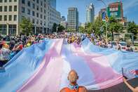 A giant Trans Flag seen at the march. Thousands of New