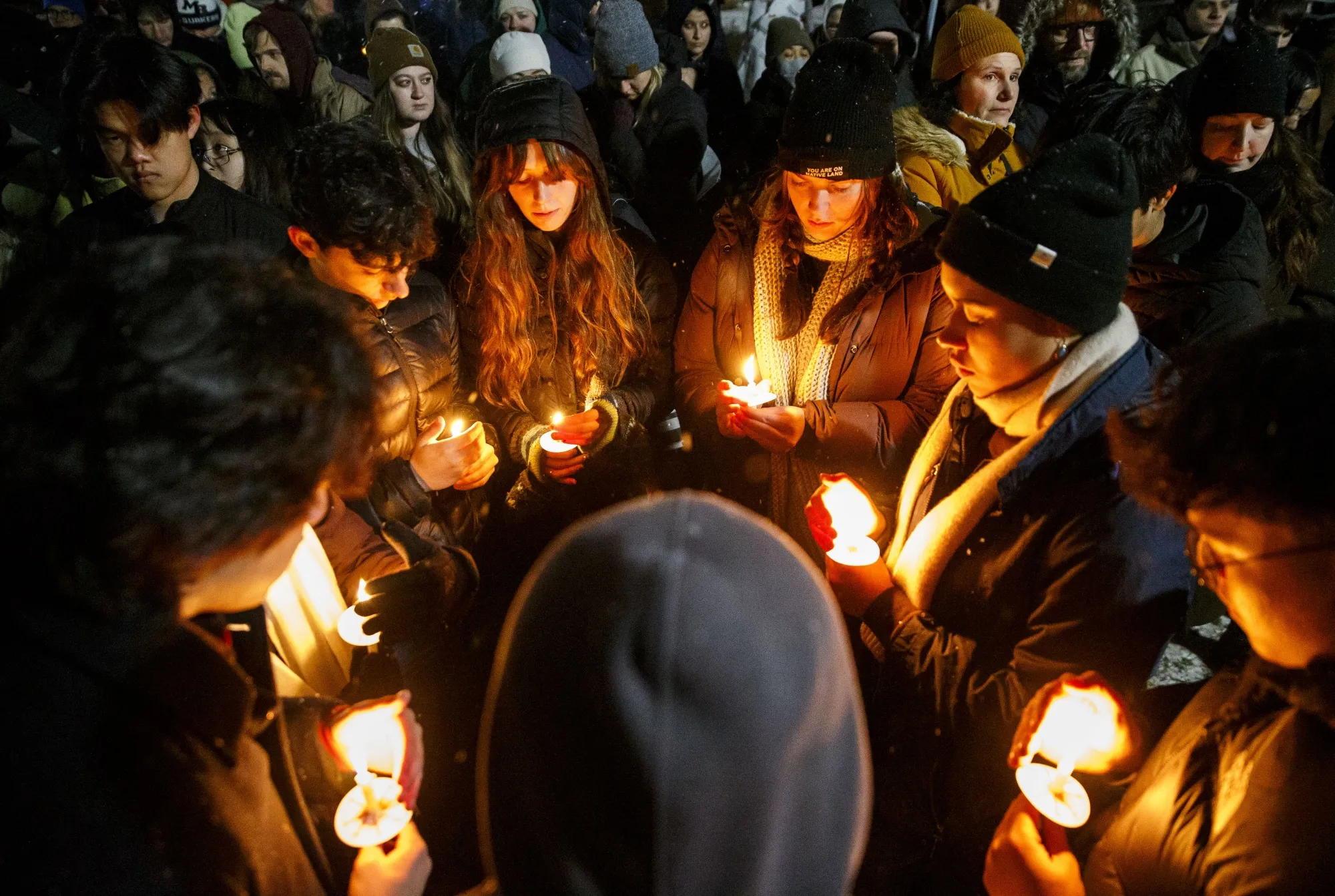 Vigil-goers hold candles and sing together following a mass shooting at Brown University in Lippitt Memorial Park in Providence, Rhode Island&nbsp;on Dec. 14.