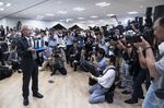 Akira Yoshino holds a model of a lithium-ion battery during a press conference on Oct. 9.