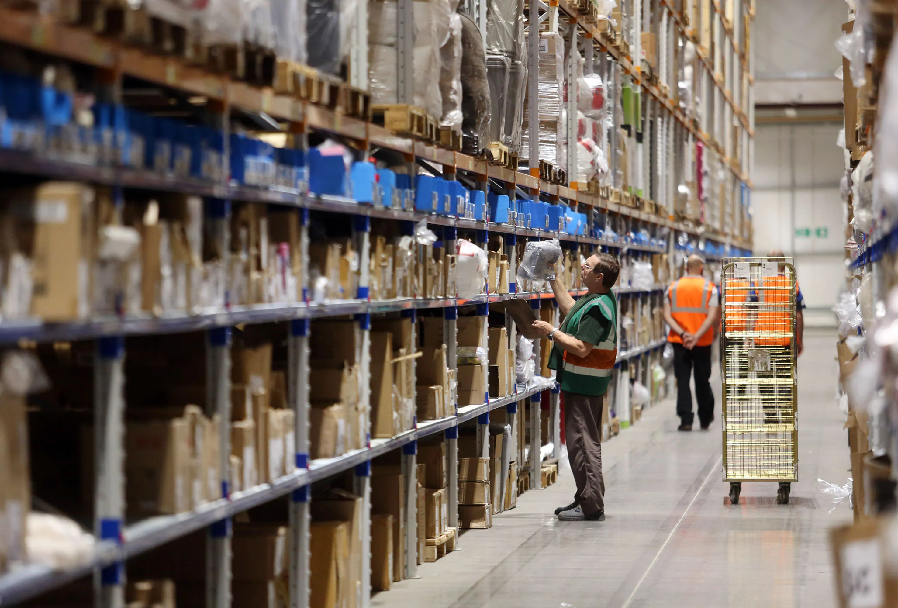 An employee picks items from racking in Shirebrook, U.K.