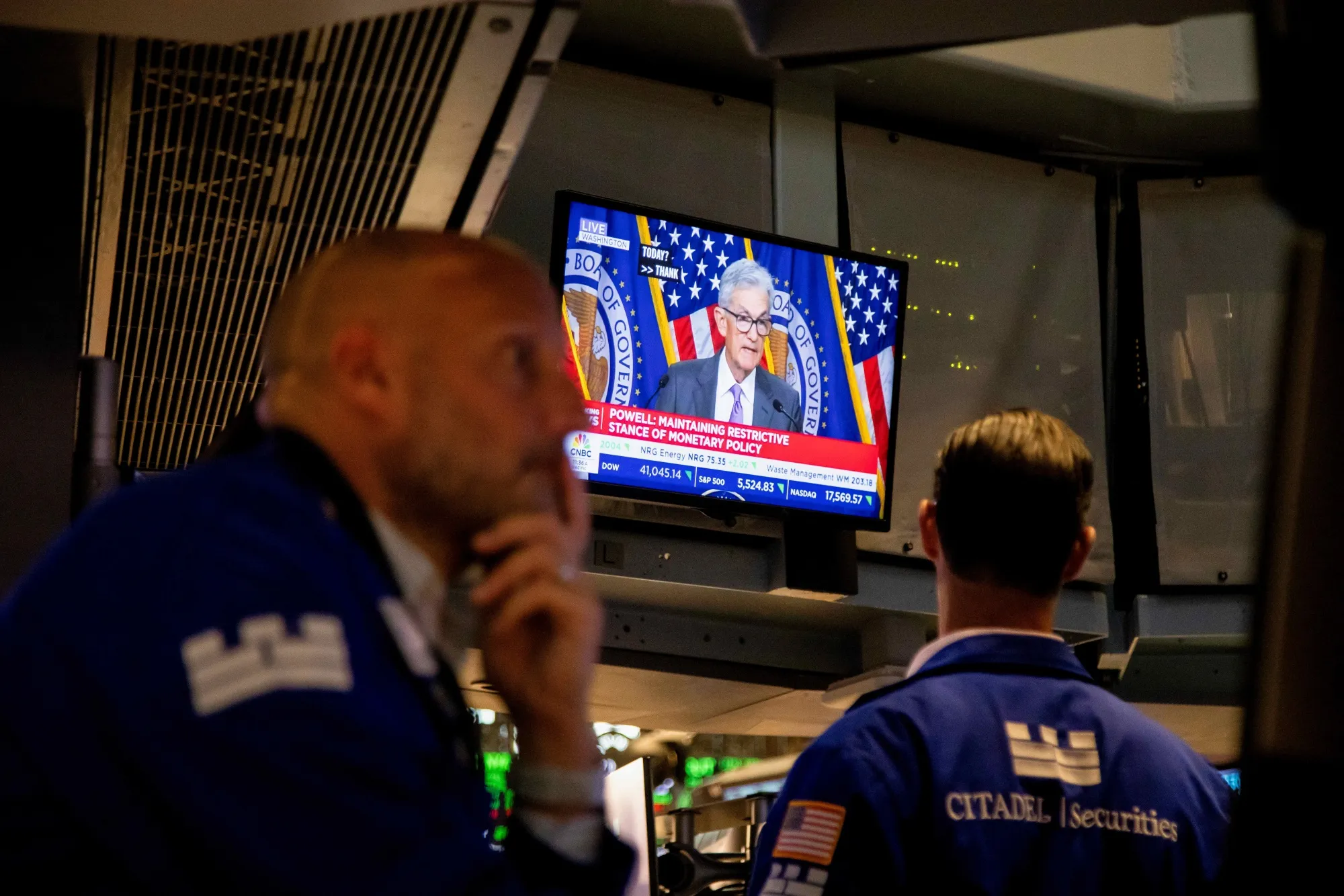 A television broadcasts Jerome Powell speaking after a Federal Open Market Committee meeting on the floor of the New York Stock Exchange&nbsp;on July 31.