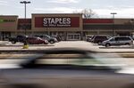 A vehicle drives past a Staples Inc. store in Clawson, Michigan.