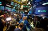 Traders work during the first day of trading for Spotify Technology SA on the floor of the New York Stock Exchange (NYSE) in New York, U.S., on Tuesday, April 3, 2018. Music-streaming service Spotify has avoided the traditional path to a stock listing, eschewing costly investment bankers and saying it wants to price its shares at a level that will ensure stability rather than a big jump on the first day of trading.