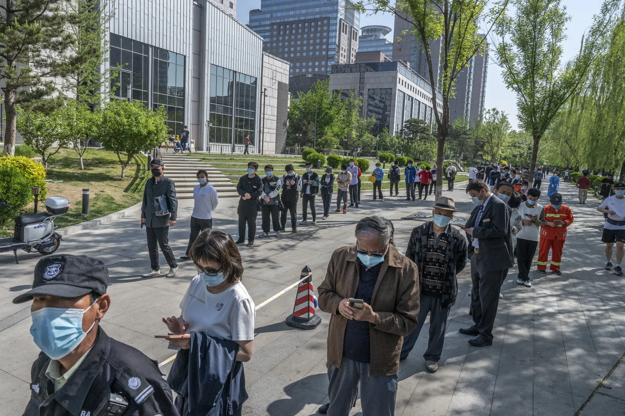 People line up at a Covid-19 testing site on Tuesday&nbsp;in Beijing.