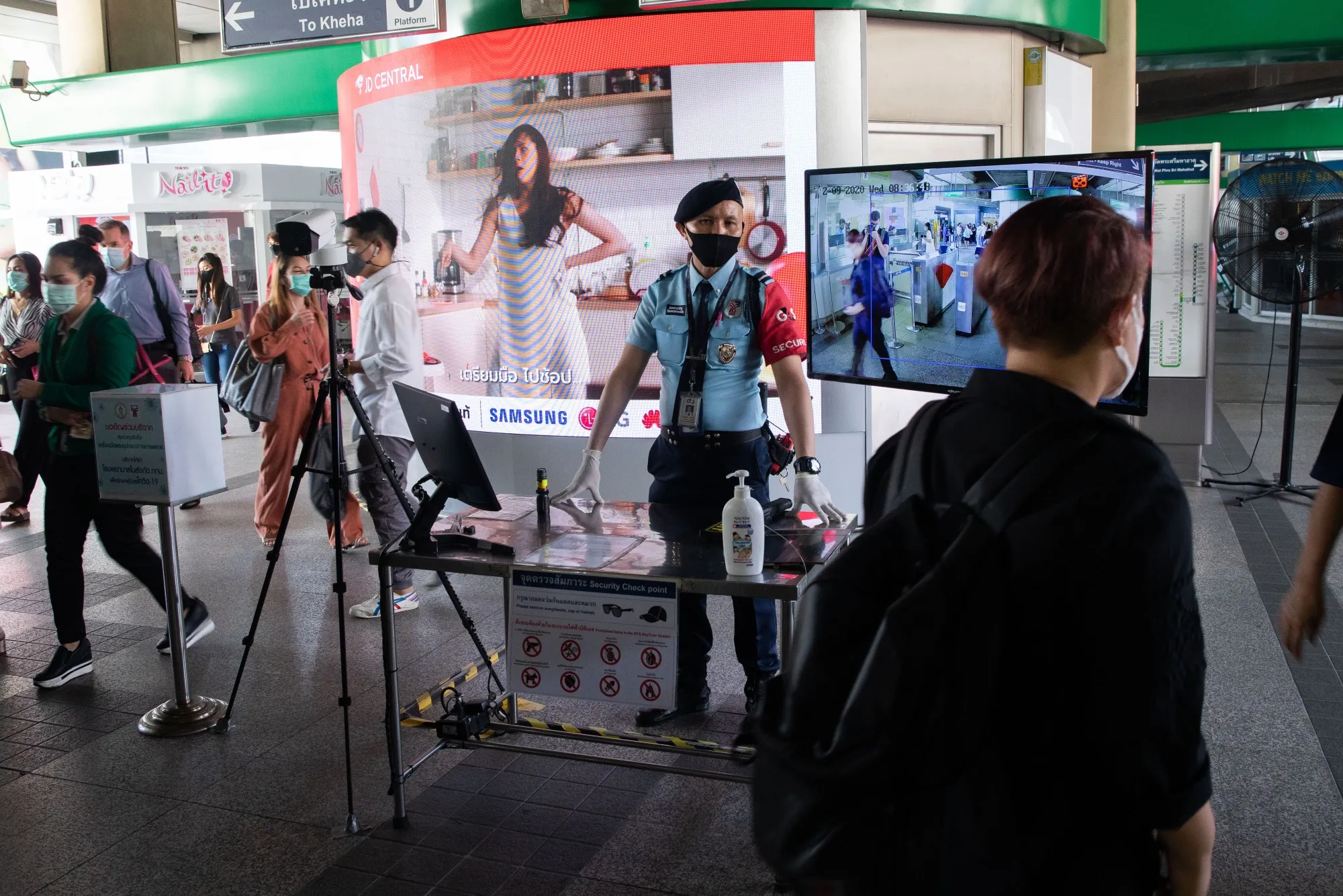 Commuters have their temperatures checked at a BTS station in Bangkok on Sept. 2.